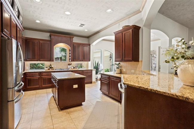 This home has Trendmakers popular raised dishwasher to the left plus built in spice racks over the cooktop. | Image 11
