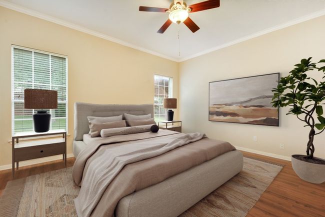 The spacious primary suite is a true retreat, complete with a luxurious bath featuring dual vanities, a walk-in shower, a soaking tub, and an oversized walk-in closet. | Image 5