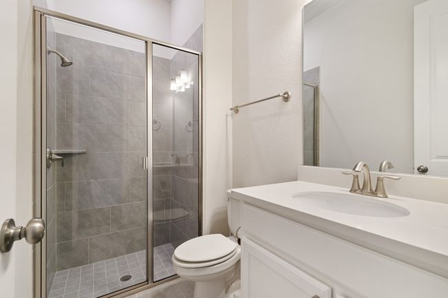 Bathroom featuring toilet, a stall shower, and vanity | Image 7