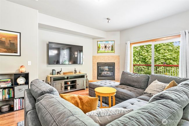 Living room with corner gas fireplace and recessed entertainment nook | Image 11