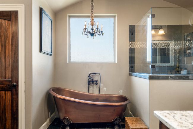 Full bath with a freestanding tub, tiled shower, a chandelier, and vanity | Image 21