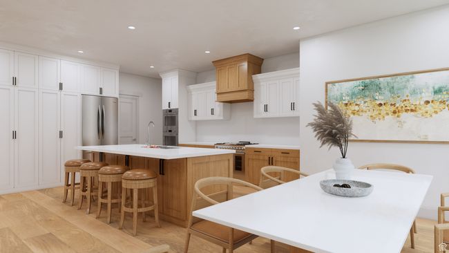 Kitchen with a kitchen breakfast bar, stainless steel appliances, light countertops, a center island with sink, and light wood-style flooring | Image 10