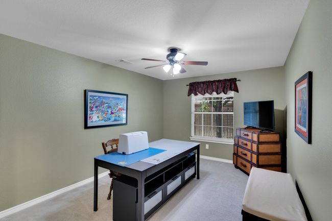 4th bedroom on 1st floor with closet and fan currently being used as a craft room | Image 28