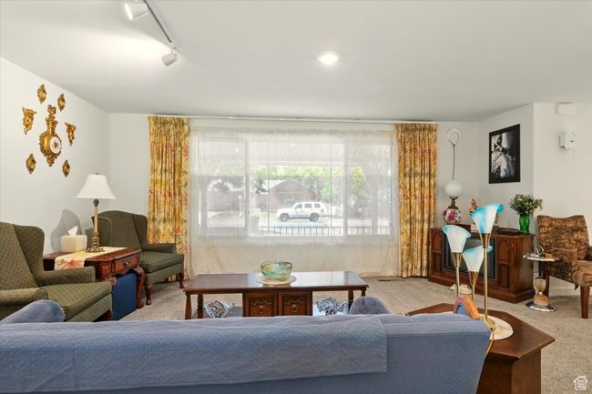 Living area with carpet and track lighting | Image 4
