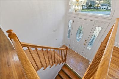 Entrance foyer with a notable chandelier and hardwood / wood-style floors | Image 2