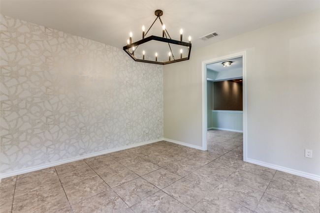Tiled spare room featuring a chandelier and wallpapered walls | Image 28