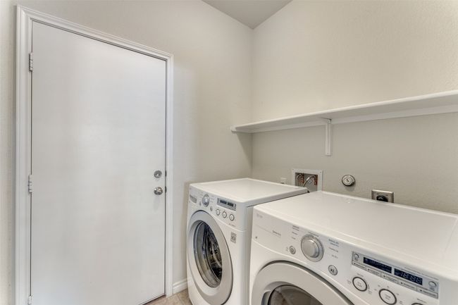Moving to the garage area, one will notice a fully separate laundry room nicely coold and heated on the interior of the home. | Image 23