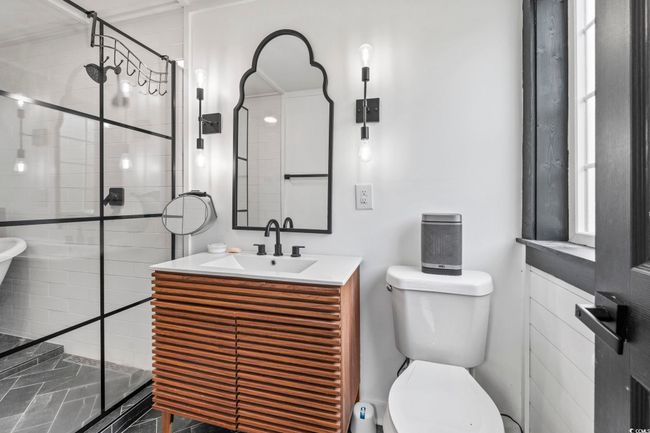 Bathroom featuring toilet, a shower stall, and vanity | Image 30