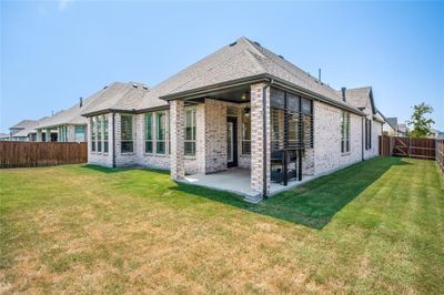 The backyard has covered patio and plenty of space for a pool. | Image 3