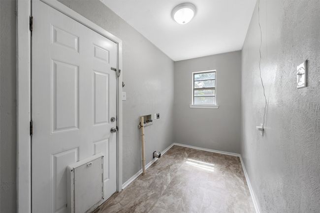 Laundry area featuring washer hookup and hookup for an electric dryer | Image 9