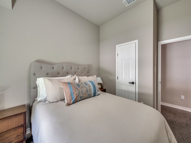 Bedroom featuring lofted ceiling, baseboards, and dark colored carpet | Image 13