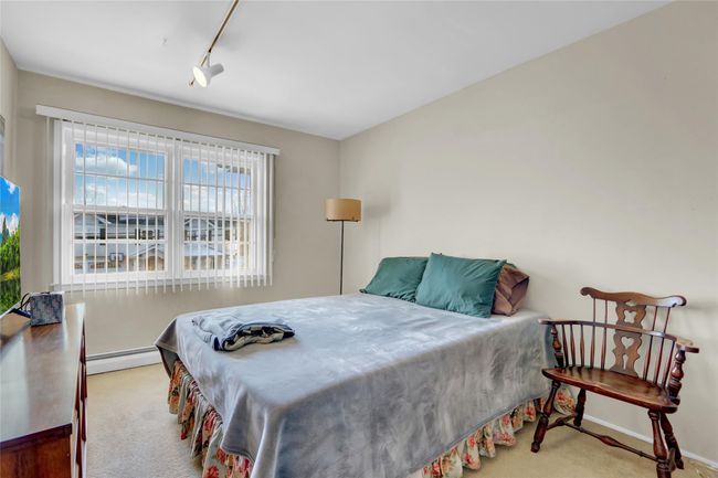 Carpeted bedroom with a baseboard radiator and track lighting | Image 23