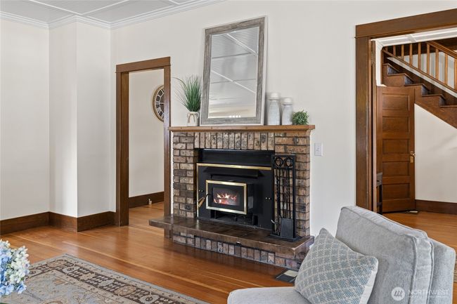 The wood-burning fireplace insert evokes classic warmth and historic character, while offering practical backup heat to complement the new HVAC system during colder months. | Image 6