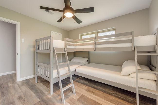 Bedroom with wood finished floors and ceiling fan | Image 26