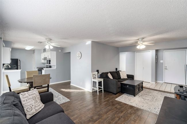 Living room with dark hardwood / wood-style floors, sink and ceiling fan | Image 8