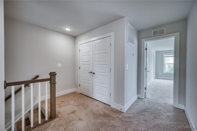 Hallway featuring carpet floors and an upstairs landing | Image 22