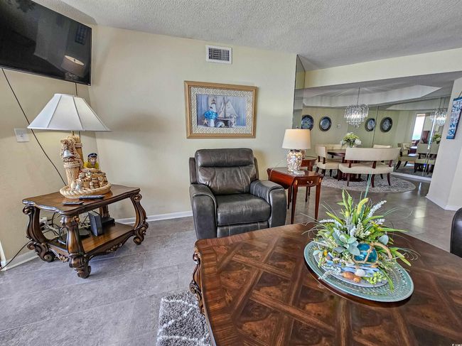 Living room with a textured ceiling and a chandelier | Image 8