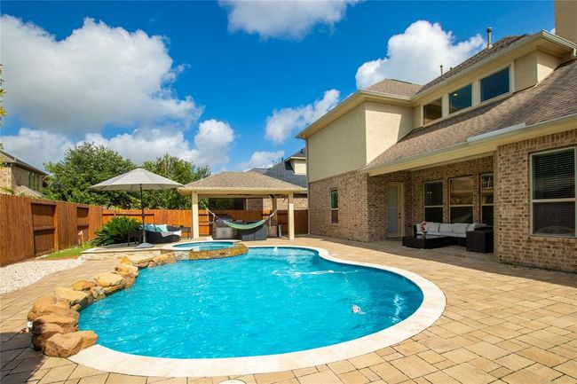 View of the pool, cabana and seating area under the covered porch. Perfect for relaxation and entertaining. | Image 41