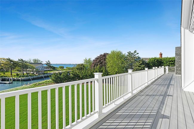 Wooden terrace featuring a water view and a yard | Image 28