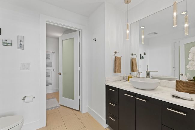 Bathroom with baseboards, visible vents, toilet, and vanity | Image 15