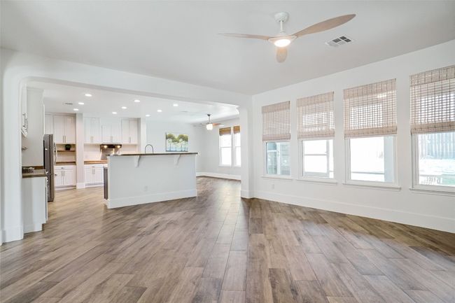 Family room view to back yard and screened in patio. wood title floor .This is the old counter tops | Image 13
