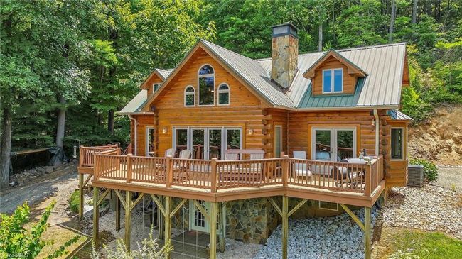 Discover serenity on the spacious deck of this charming cabin, where sweeping, long-range mountain views create an unforgettable backdrop. | Image 4