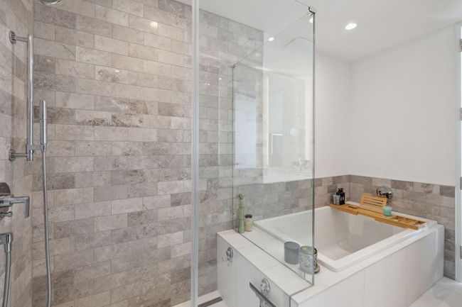 Bathroom with a shower stall, a bath, tile walls, and recessed lighting | Image 23