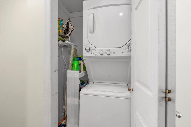Laundry room with stacked washer and dryer and laundry area | Image 12
