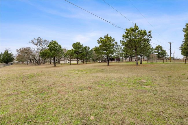 View of yard with a rural view and fence | Image 46