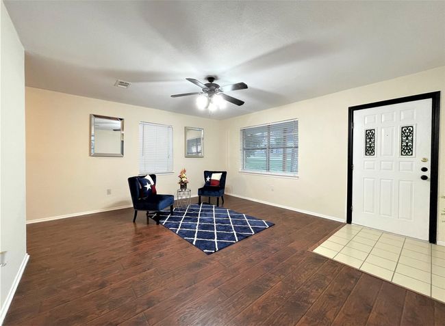 Sitting room with wood finished floors and a ceiling fan | Image 6