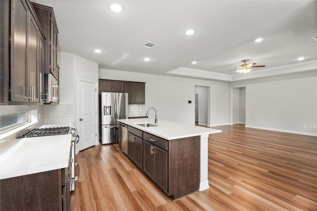 Dining room featuring dark wood-type flooring and baseboards | Image 14