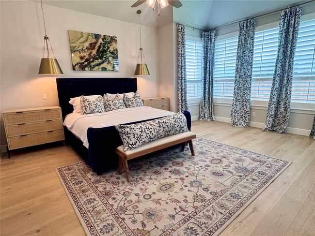 Bedroom featuring light wood-style floors and a ceiling fan | Image 20