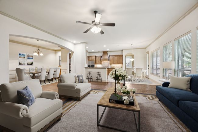 Living room featuring ornamental molding, arched walkways, a ceiling fan, a chandelier, and recessed lighting | Image 7