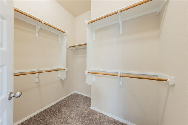 Walk in closet with carpet floors | Image 13