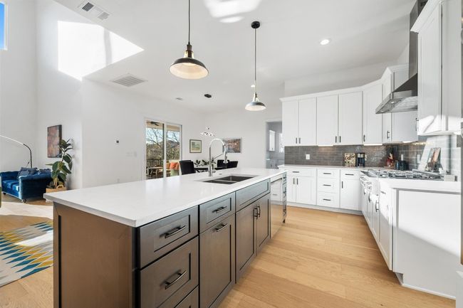 The gourmet kitchen features a built-in electric oven, impressive gas cooktop providing a professional culinary experience with high performance and timeless style | Image 10