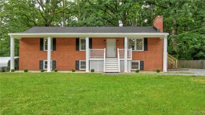 Bi-level home with a front yard and a porch | Image 1