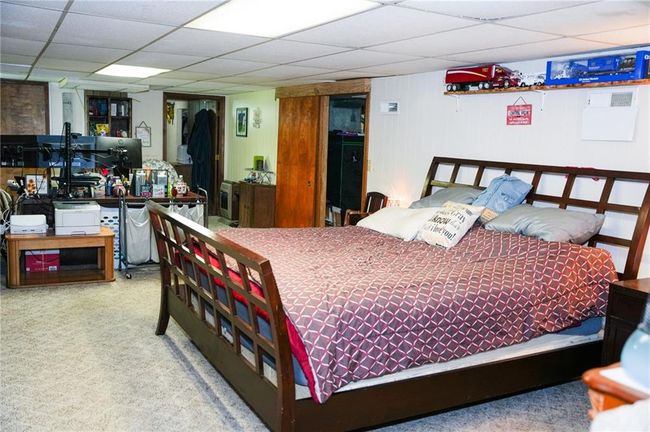 Bedroom with a paneled ceiling and carpet flooring | Image 19