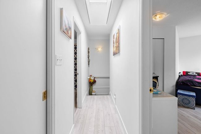 Corridor featuring light wood-style flooring and attic access | Image 18