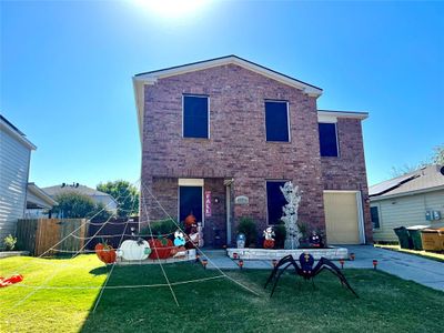 Front of property with a yard and a garage | Image 1