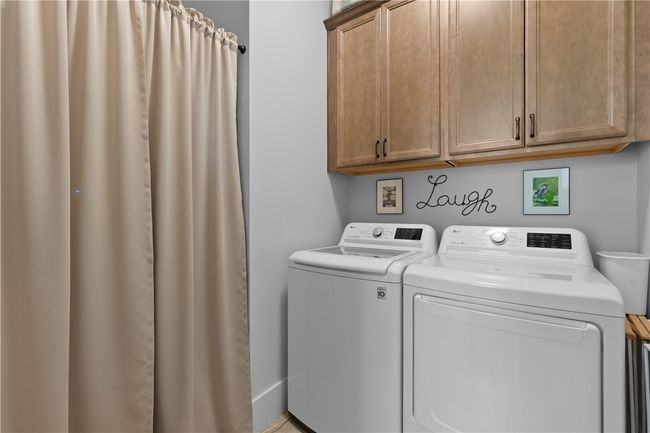 Laundry room. Hot water heater behind the curtain. | Image 17