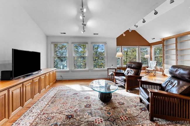 Living area with rail lighting, light wood-type flooring, and vaulted ceiling | Image 46
