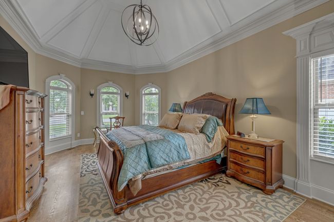 Look at the beauty in this shot: bay windows, tray ceiling, hardwood floors, and modern light fixtures. Your Primary Suite awaits! | Image 23