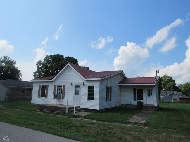 view of front of home with a metal roof and crawl space | Image 18