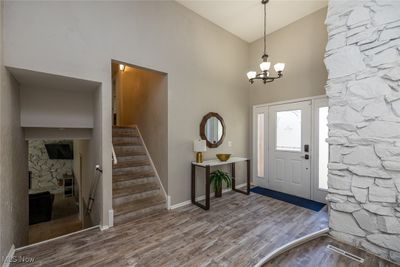 Foyer with high vaulted ceiling, a chandelier, and hardwood / wood-style floors | Image 3