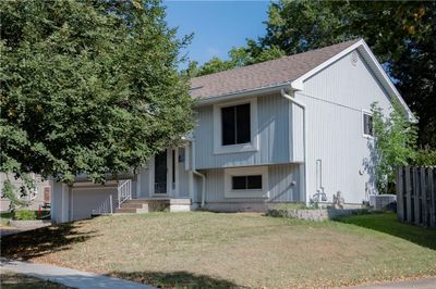 View of front of home with central AC, a front yard, and a garage | Image 3