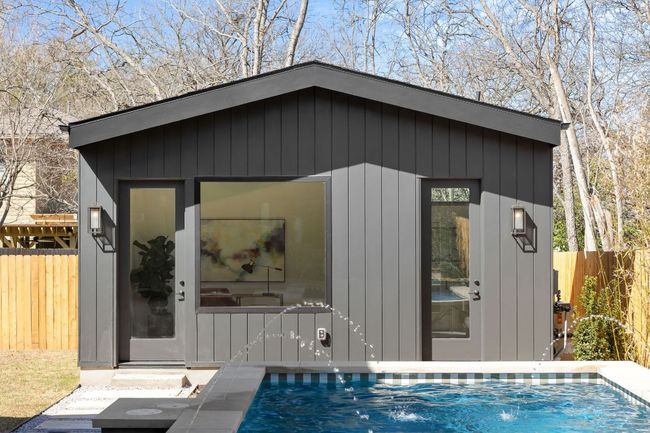 View of pool house featuring a swimming pool and fence | Image 33