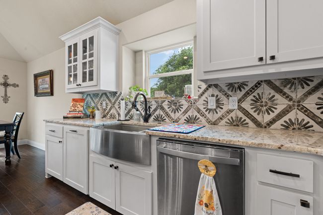 Kitchen with dishwasher, decorative backsplash, dark wood-style floors, glass insert cabinets, and vaulted ceiling | Image 10