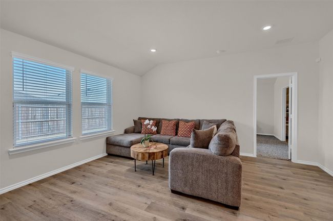 Living area featuring light wood-type flooring, recessed lighting, and vaulted ceiling | Image 7
