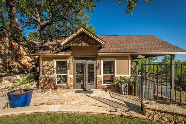 Rear view of property with a shingled roof, a patio, stone siding, and stucco siding | Image 29
