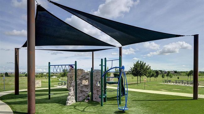 Communal playground featuring a lawn | Image 9